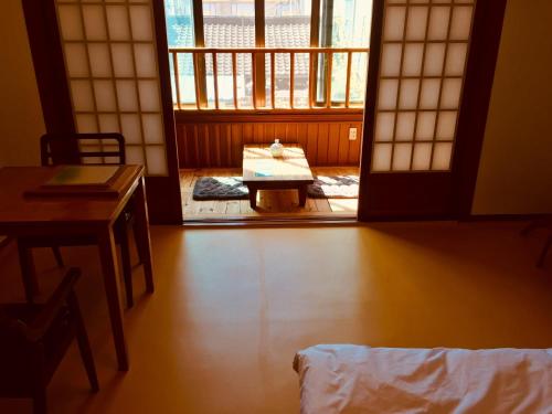 a room with a door and a table and a desk at BluePlanet in Gyeongju
