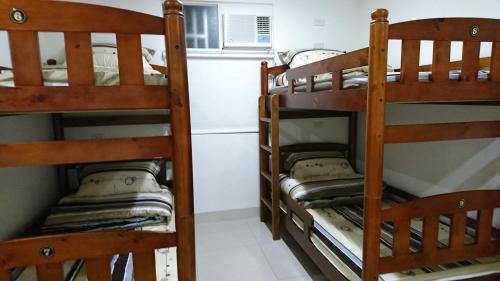 two bunk beds in a room with a microwave at Guotai Backpack in Kaohsiung