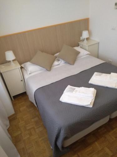 a bedroom with a large bed with two night stands at Affittacamere Iris in Trieste