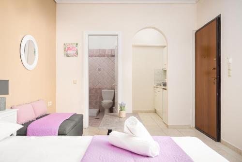 a bedroom with two beds and a bathroom at joseph apartment in Corfu Town