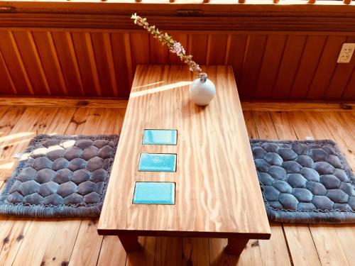 a wooden table with a vase on it in a room at BluePlanet in Gyeongju