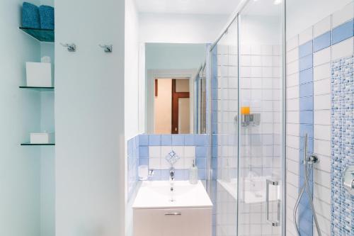 a bathroom with a sink and a shower at Lemon in the Air in Scala