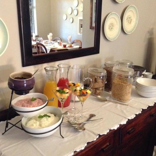a buffet with bowls and glasses of food on a counter at Gerald's Gift Guest House in Addo