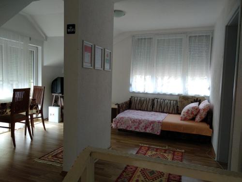 a bedroom with a bed in a room with windows at Family House Near Motorway 6 Guests 3 Bedrooms in Veles