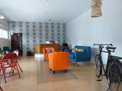 a living room with orange chairs and a blue couch at Home Addicts Hostel in Yogyakarta
