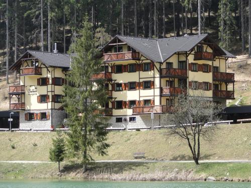 a large apartment building on a hill next to the water at Apartment Barbora 7 in Ružomberok