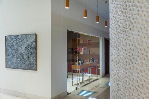a hallway with a white wall with a picture on it at The Park Navi Mumbai in Navi Mumbai