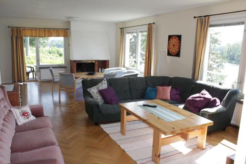 a living room with a couch and a table at Liljeholmen Herrgård Hostel in Rimforsa