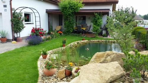 a house with a pond in the yard at Apartmán v rodinném domě in Hradec Králové