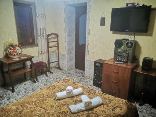 a room with a bed with rolled towels on it at Hostel Sadu Kutaisi in Kutaisi