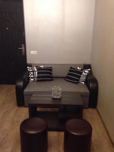 a couch with pillows and a table in a room at Niki in Mtskheta