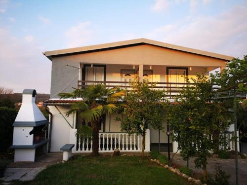 a house with a lighthouse in front of it at Apartments Samaržija- new 63 not 47 in Bibinje