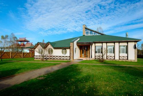 a large house with a green roof at Brech Resort&Spa in Gurinovka Staraya