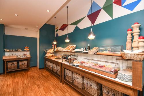 a bakery with a counter with food on it at Hotel City in Desenzano del Garda