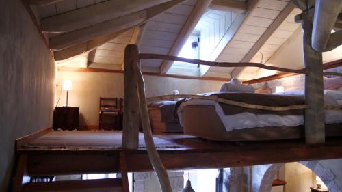 a bedroom with two bunk beds in a attic at Artsistas Houses in Aristi