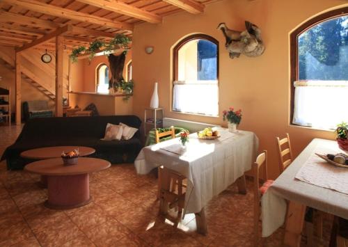 a living room with a table and a couch at Penzión Ľadová in Stratená