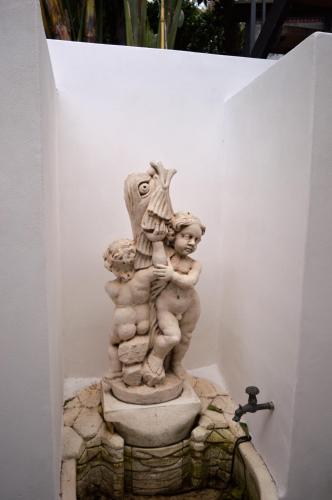 a statue of a child standing on a fountain at B&B Il Giardino Segreto in Stromboli