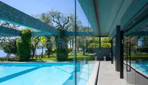 an external view of a house with a swimming pool at Hotel Villa Giulia in Gargnano