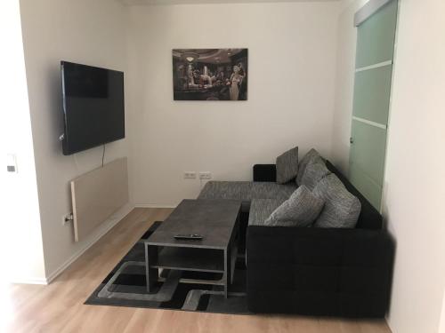 a living room with a couch and a table at Ferienwohnung An der alten Weed in Bad Windsheim