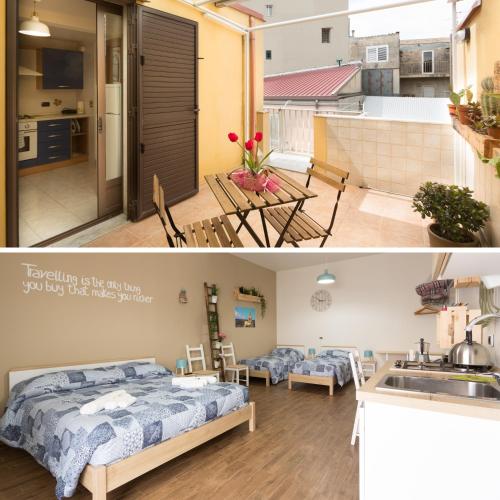 a kitchen and a living room with a bed in a room at Pura Vida Barocca in Ragusa