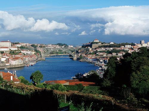 a view of a river with a city and a bridge at Hotel ibis Porto Gaia in Vila Nova de Gaia