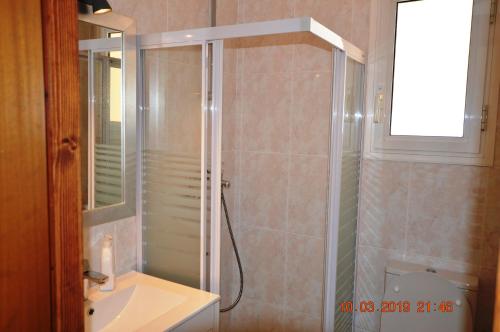 a bathroom with a shower and a sink and a toilet at Can Tapsy in Tossa de Mar