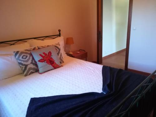a bed with two pillows on top of it at Monte da Esperanca in Esperança