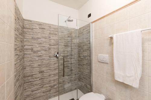 a bathroom with a toilet and a shower stall at Hotel San Marco in Gubbio