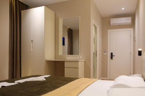 a bedroom with a bed with a large mirror at Star Hotel in Tirana