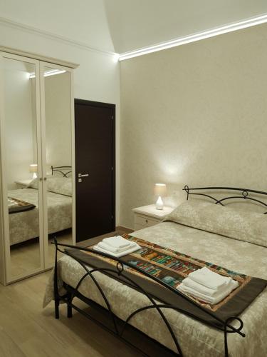 a bedroom with a bed and a large mirror at B&B da Mammina in Taranto