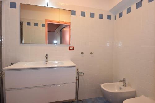 a bathroom with a sink and a toilet and a mirror at Antica Residenza I Ronchi Di Bellagio in Bellagio