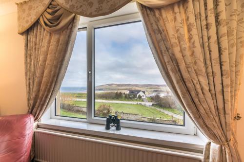a window with a view of the countryside at The Sheiling B&B - NC 500 in Melvich