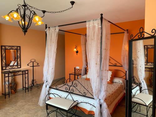 a bedroom with a four poster bed with curtains at Alacena Alfarera in Pereruela