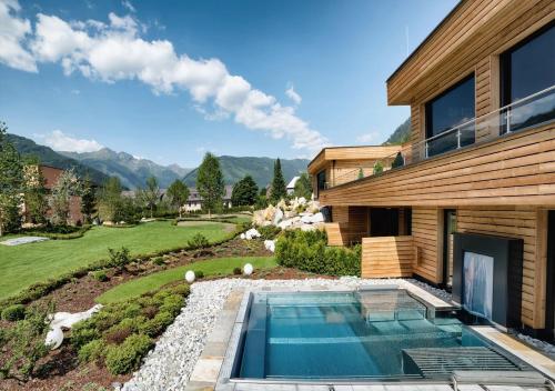 an image of a house with a swimming pool at Wellnesshotel Eggerwirt in Sankt Michael im Lungau