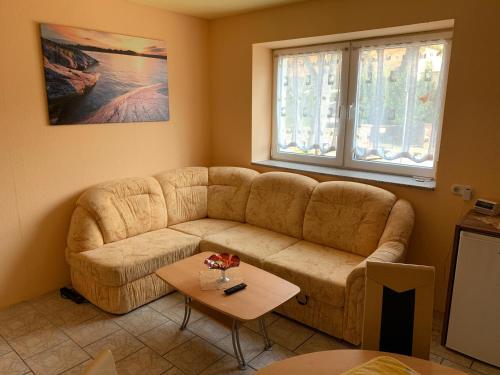 a living room with a couch and a table at Ferienwohnung Götze in Irxleben