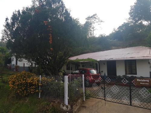 a house with a car parked in front of it at Rheinberg Town Haus in Munnar