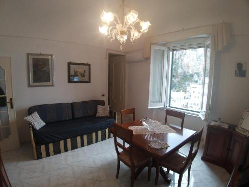 a living room with a couch and a table at Casa Eden in Atrani