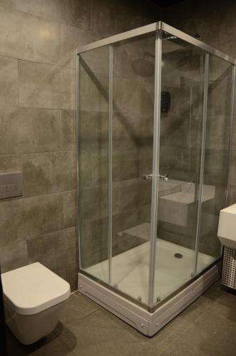 a shower stall in a bathroom with a toilet at Teknosports Otel in Istanbul
