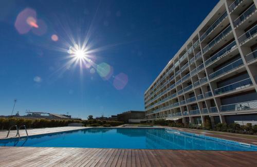 a large apartment building with a swimming pool at Charming Apartment with Balcony & Pool in Lisbon