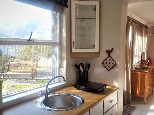 a kitchen counter with a sink and a window at Sandpiper's Nest - Hout Bay in Hout Bay