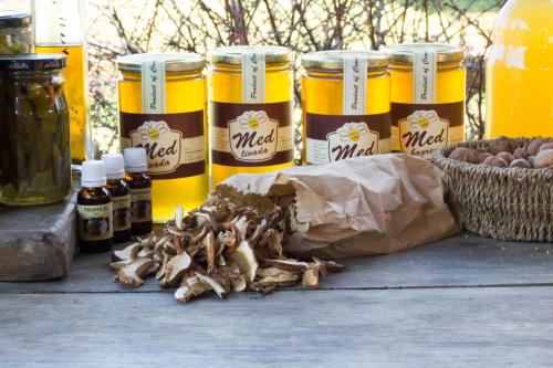 a table with jars of mustard and a bag of mushrooms at Dorina hiža in Karlovac