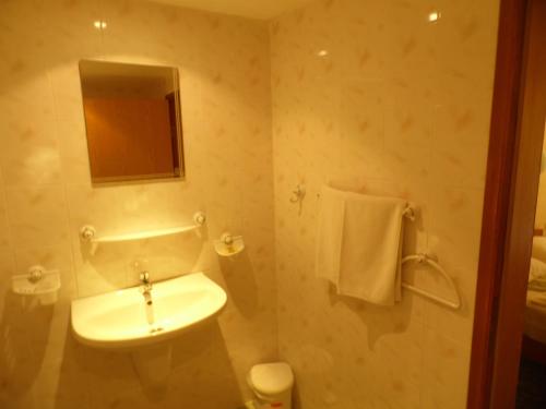 a bathroom with a white sink and a mirror at Park Hotel Kamchia in Kamchia