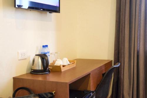 a room with a table with a coffee maker on it at CREVICE HOTEL in Davao City