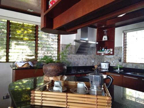 a kitchen with a table with a tea kettle on it at Ancelle Cristo Re in Moalboal