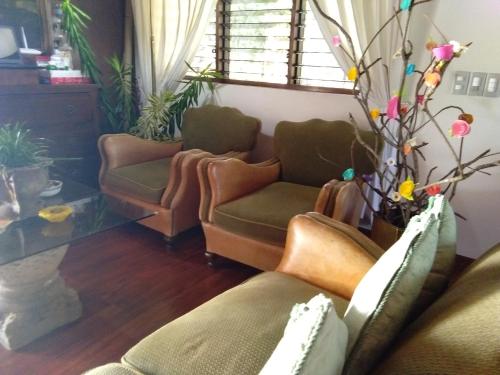 a living room with two couches and a window at Ancelle Cristo Re in Moalboal