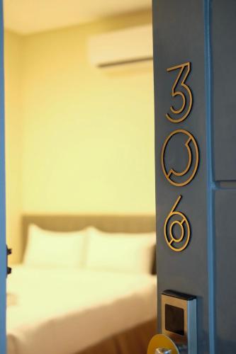 a bedroom with a bed with the number on it at CREVICE HOTEL in Davao City