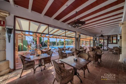 a restaurant with tables and chairs on a patio at Dulce Nombre Tarifa in Tarifa