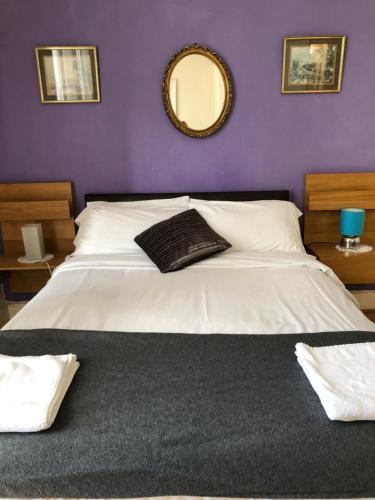a bed with a white bedspread and pillows at Counan Guest House in Edinburgh