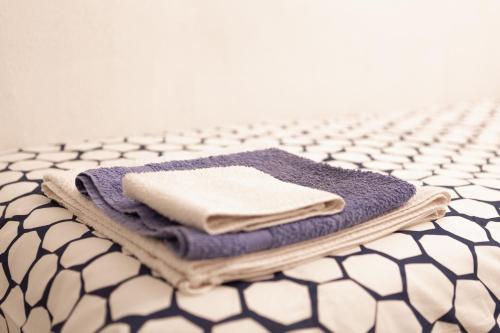 a pile of towels sitting on top of a table at B&B La Casa del Cuoco - Piccola camera con colazione in appartamento condiviso con l'host in Genova