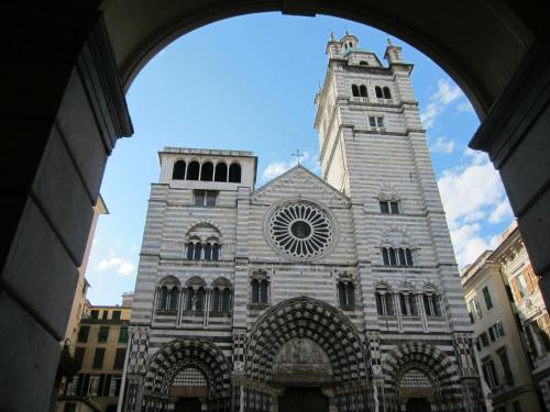 a large building with a clock tower on top at B&B La Casa del Cuoco - Piccola camera con colazione in appartamento condiviso con l'host in Genova